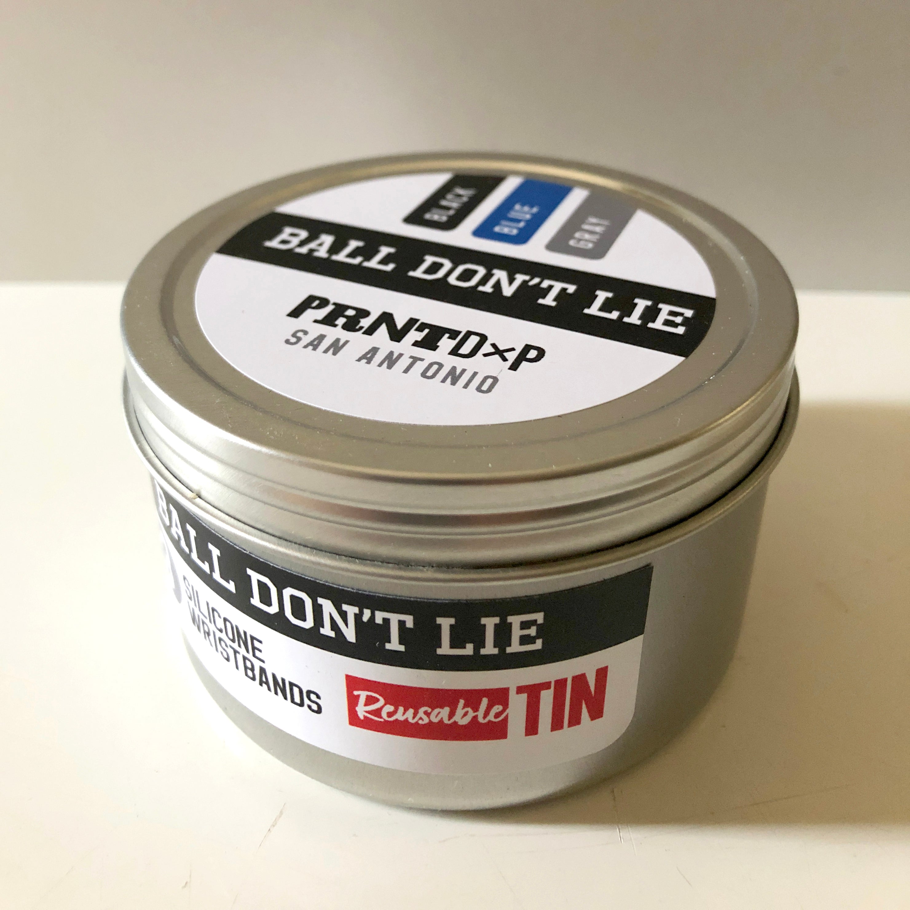 Small silver tin with sticker graphics