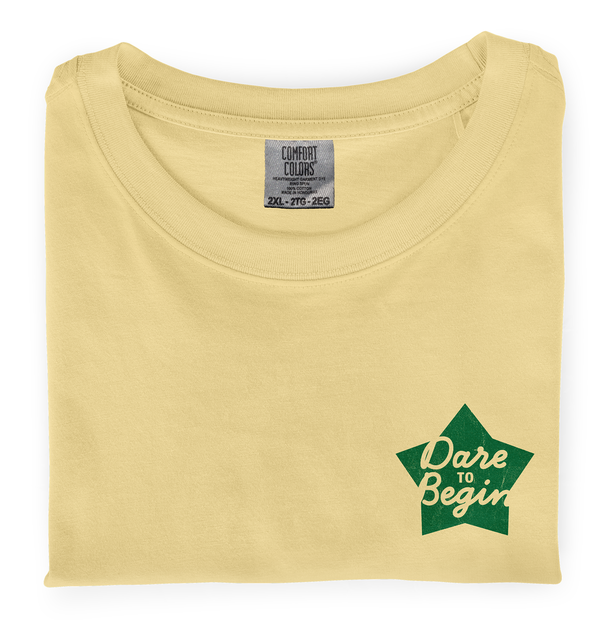 Picture of a folded, butter dyed-ink comfort colors t-shirt with  an screen printed  imprint on the chest that says Dare to Begin.