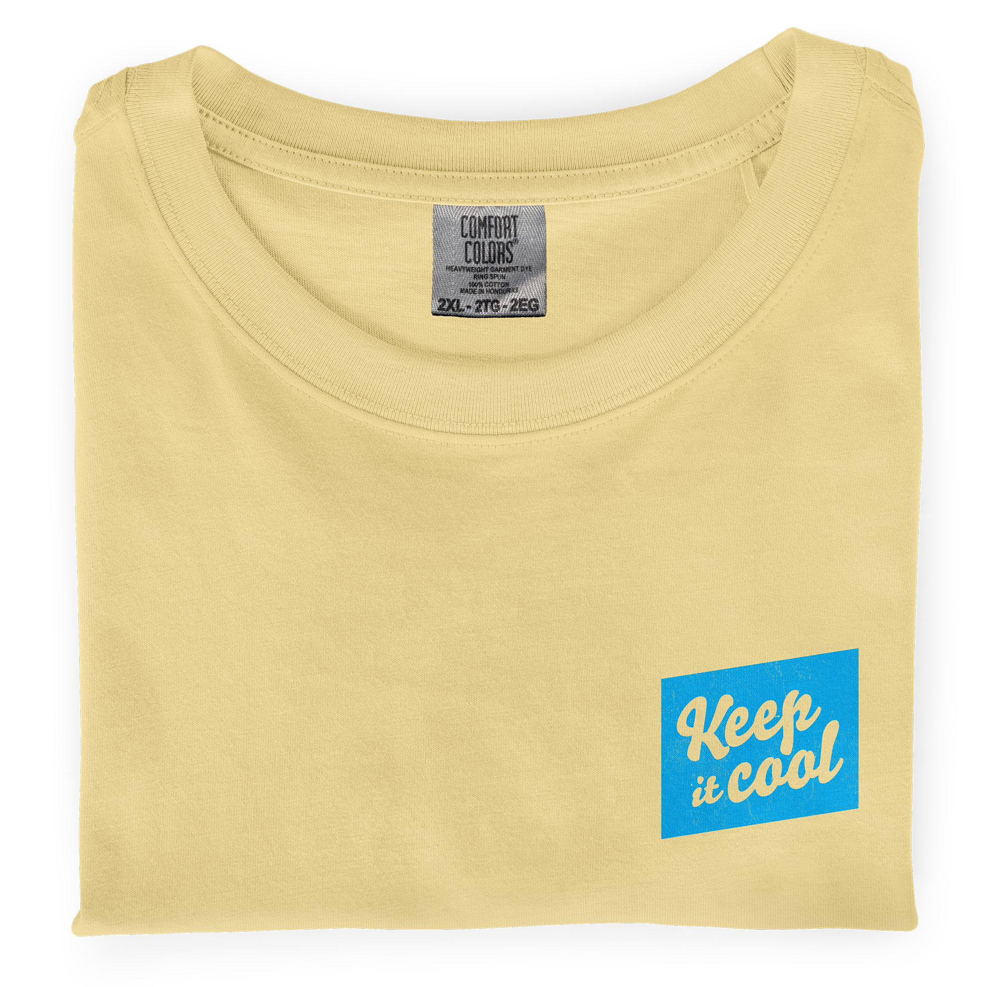 A close-up photo of a folded, butter colored dyed-ink comfort colors t-shirt with a front chest screen printed graphic that says Keep It Cool 