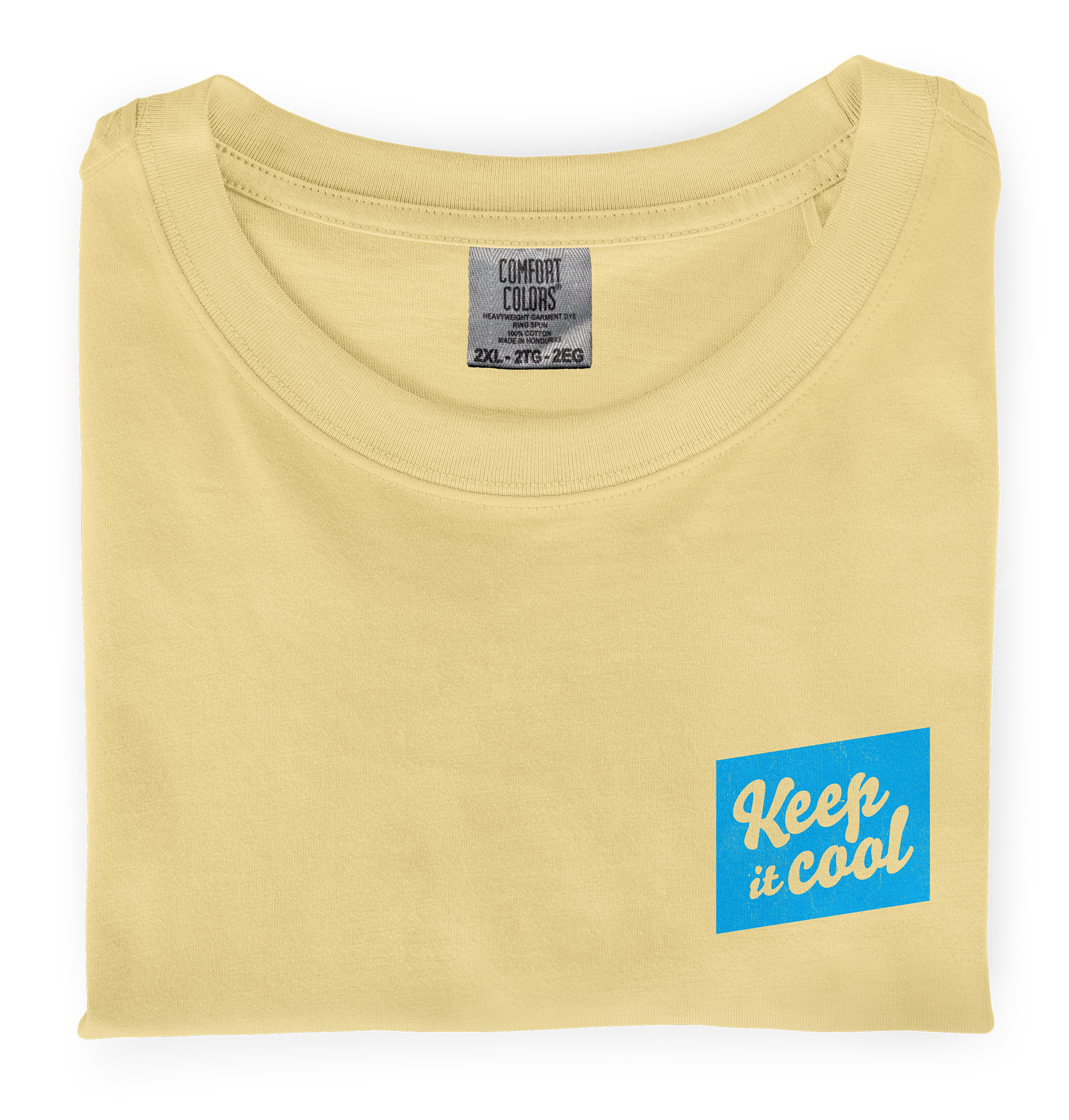 A close-up photo of a folded, butter colored dyed-ink comfort colors t-shirt with a front chest screen printed graphic that says Keep It Cool 