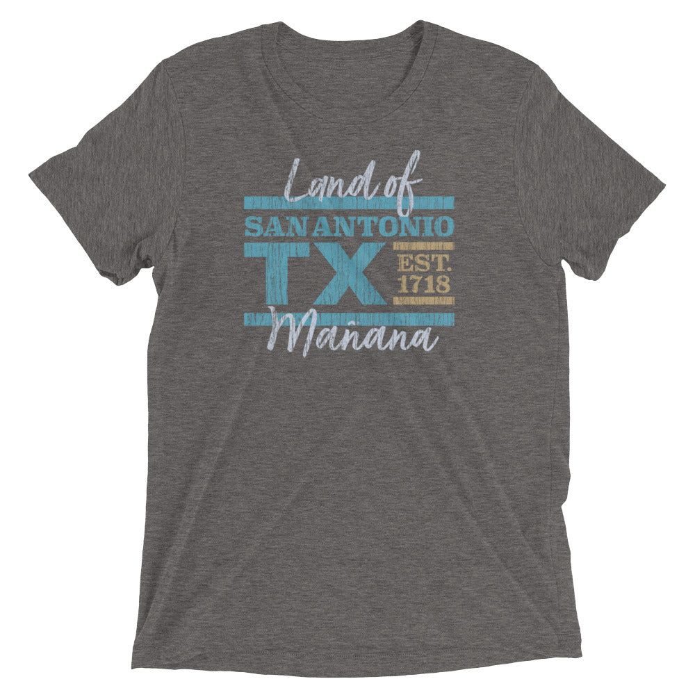 A wrinkled gray unisex t-shirt that has a distressed graphic printed on it that reads San Antonio, Texas