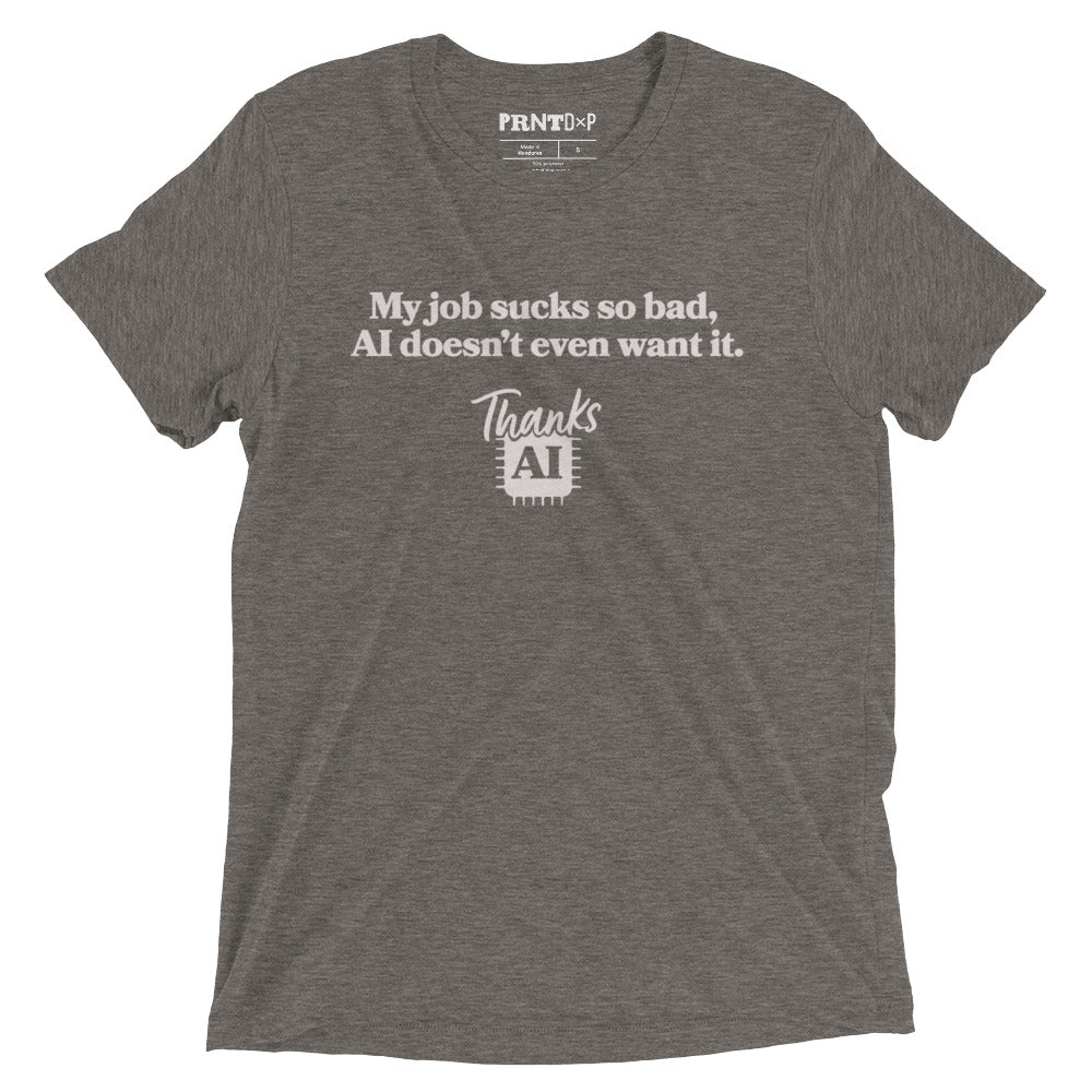 A photo of a flat t-shirt with a graphic printed on the front that says My Job Sucks So bad, AI doesn't even want it, Thanks AI.